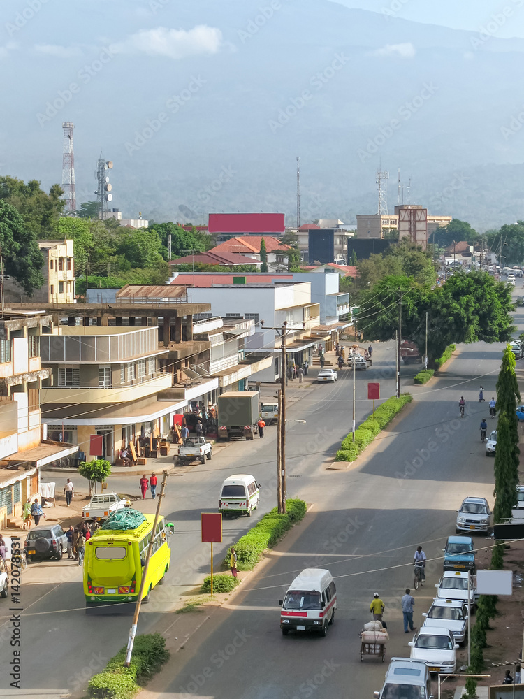 Top view on Moshi city street  against Mount Kilimanjaro background. Great Rift Valley, Tanzania, East Africa.
