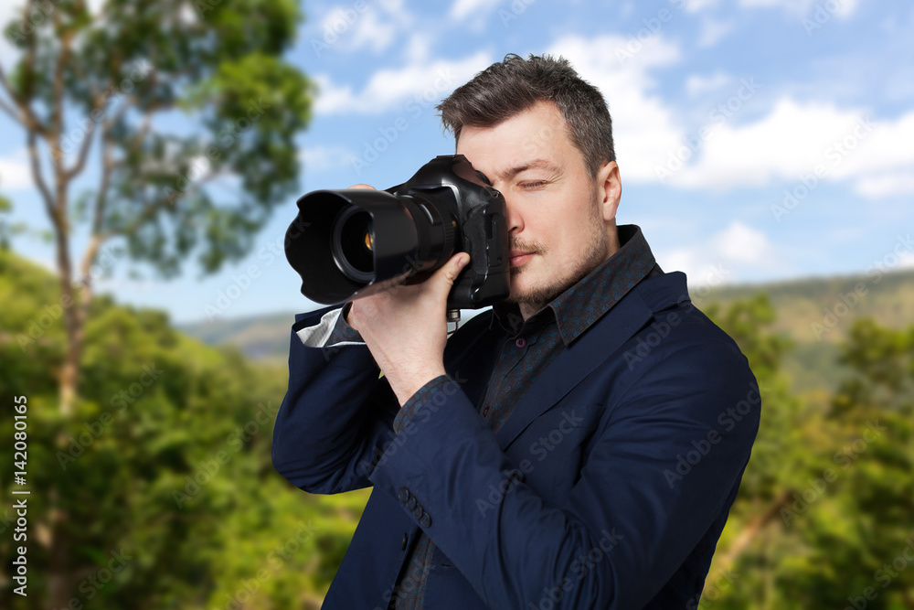 Photographer with photo camera takes the picture Photographer with photo camera takes the picture