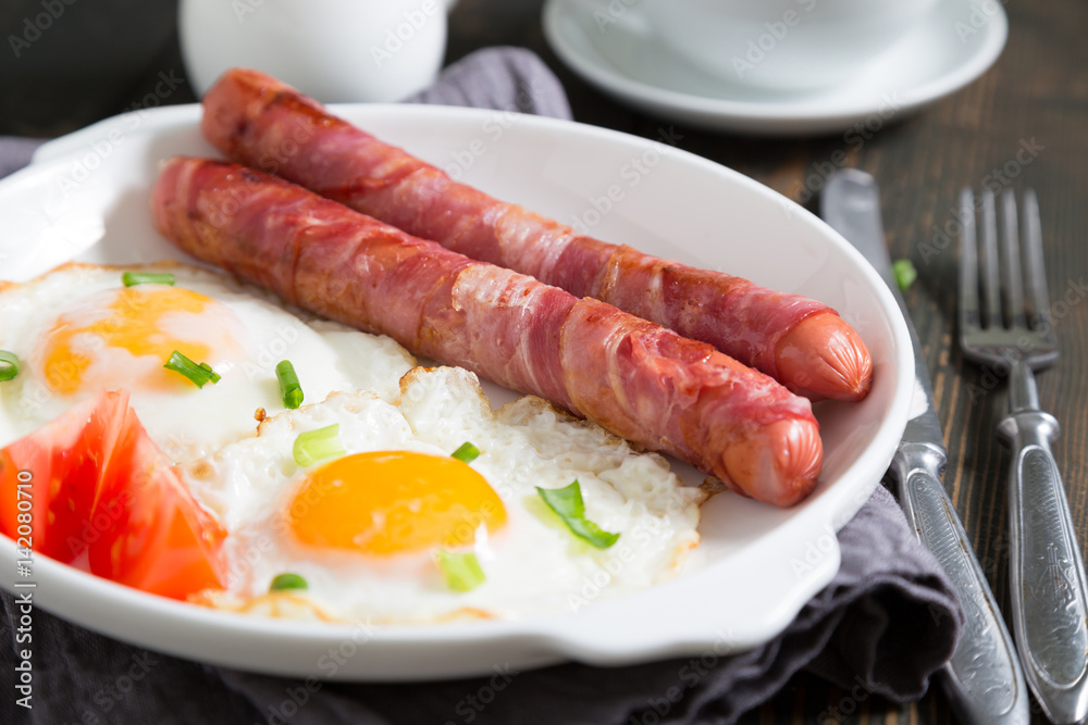 Fried eggs with sausages, breakfast Fried eggs with sausages, breakfast