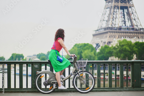 Canvas Print Woman riding a bicycle on a street of Paris