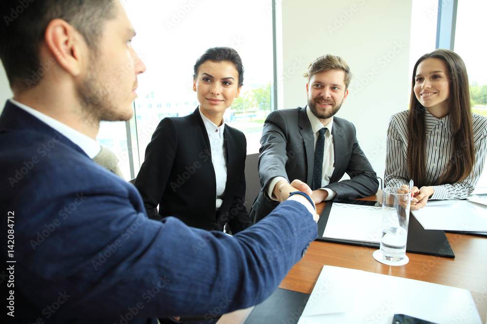 Business people shaking hands, finishing up a meeting. Business people shaking hands, finishing up a meeting.