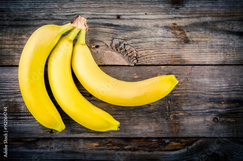 Bunch of raw organic banana on wooden background