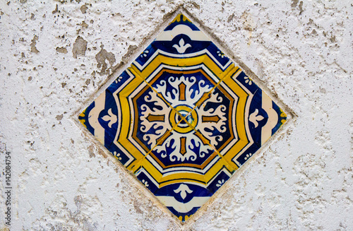 Colorful tile on the white facade in Porto, Portugal