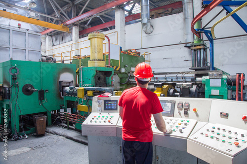 Принти на полотні worker behind the dashboard in the workshop for the production of aluminum profiles