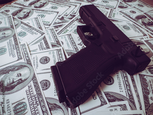 Moneys and gun concept.