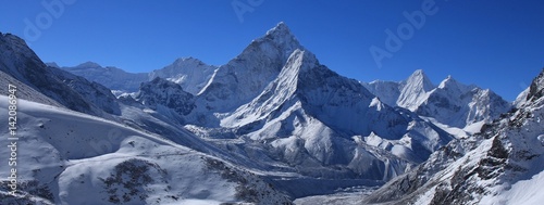 Clear blue sky over snow covered mount Ama Dablam. Morning after new snowfall. Scene in the Mount Everest National Park.