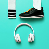 Minimal fashion creative art. Urban street vibrations. Music and sports. Sneakers and headphones.