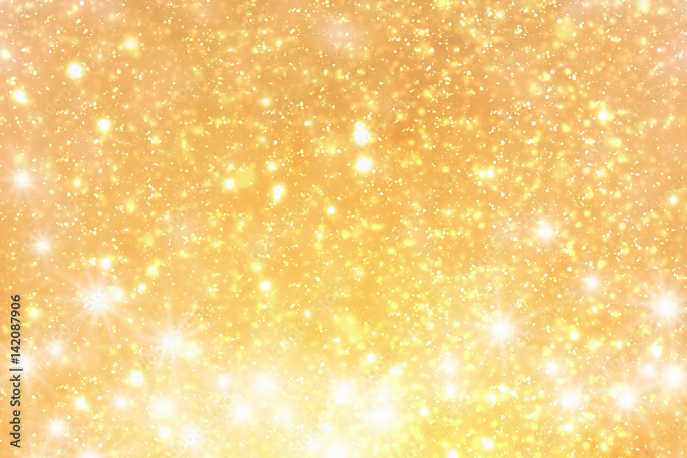Golden rays and sparkles or glitter lights. Merry Christmas festive background.defocused circle bokeh or particles Golden rays and sparkles or glitter lights. Merry Christmas festive background.defocused circle bokeh or particles