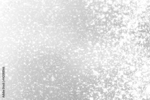 Snowflakes bokeh or glitter lights festive silver background. Christmas abstract template
