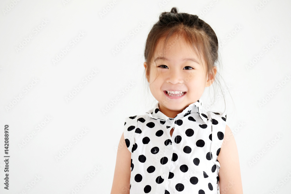 Cute little asian girl smiling in white bedroom background, happy expression emotion Cute little asian girl smiling in white bedroom background, happy expression emotion