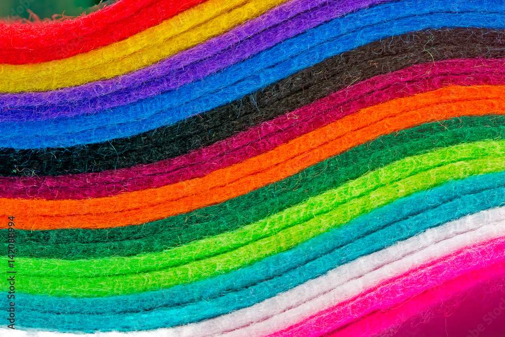 Abstract vivid rainbow colour pattern from close-up of layers of material