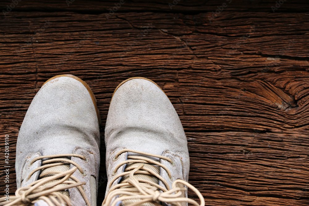hiking boots on old wood table. Copy space for your text hiking boots on old wood table. Copy space for your text