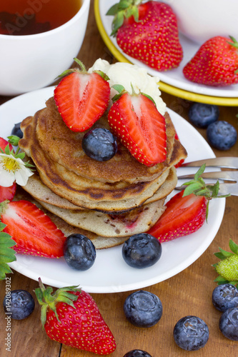 Delicious pancakes with with strawberry and blueberry