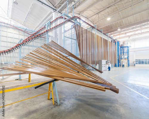 powder coating system. painting and drying of aluminum profiles on a conveyor belt