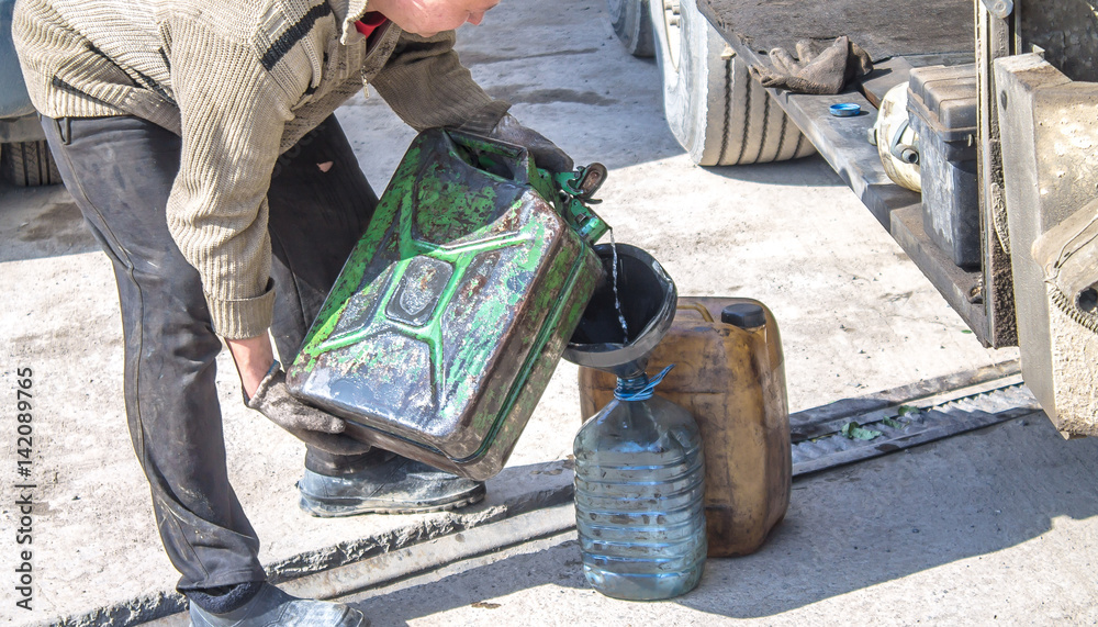 Overflow of diesel fuel from canister Refueling canisters Stock Photo