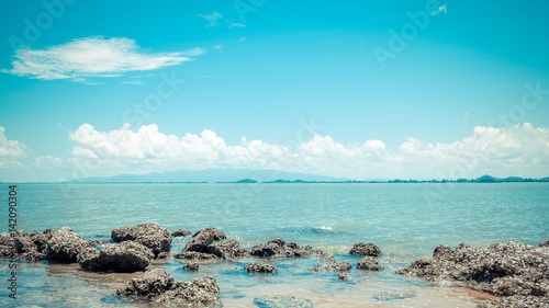 Beach and sea with blue sky and reef rock beach