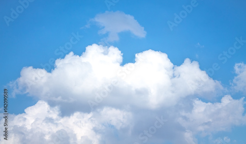 White cumulus clouds against blue sky