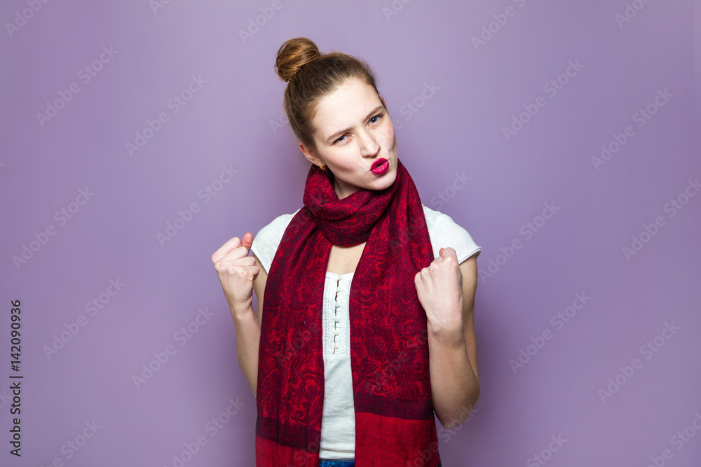 Surprised winner woman. Young emotional beauty with collected hair, freckles and red scarf looking excited on purple background, emotions, expressions, success concept and celebrating victory. Surprised winner woman. Young emotional beauty with collected hair, freckles and red scarf looking excited on purple background, emotions, expressions, success concept and celebrating victory.