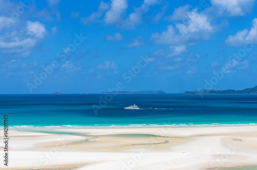 White cruise ship  boat on turquoise blue waters of Coral sea