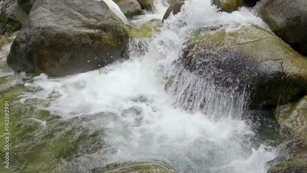 fast mountain stream among the stones spring a thaw in the forest fast mountain stream among the stones spring a thaw in the forest