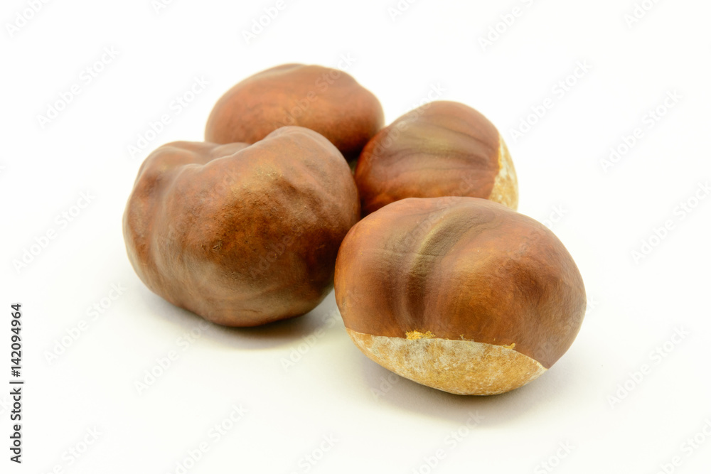 Closeup chestnuts isolated on white background. Fresh autumn chestnut. Sweet natural fruit the chestnut tree. Sign of autumn. Autumn decoration from chestnuts. Closeup chestnuts isolated on white background. Fresh autumn chestnut. Sweet natural fruit the chestnut tree. Sign of autumn. Autumn decoration from chestnuts.
