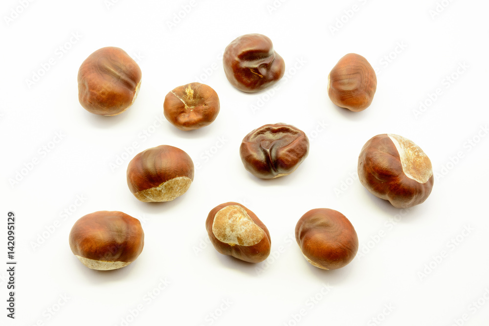 Closeup chestnuts isolated on white background. Fresh autumn chestnut. Sweet natural fruit the chestnut tree. Sign of autumn. Autumn decoration from chestnuts. Closeup chestnuts isolated on white background. Fresh autumn chestnut. Sweet natural fruit the chestnut tree. Sign of autumn. Autumn decoration from chestnuts.