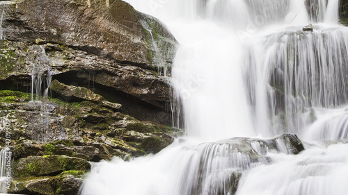 Waterfall in the mountains. Early spring in the Carpathians Ukraine. Travel.