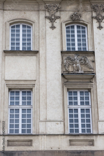 Four vintage design windows on the facade of the old house.