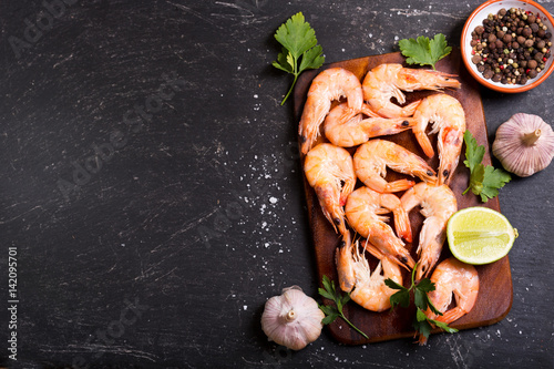 shrimps with lime on dark table