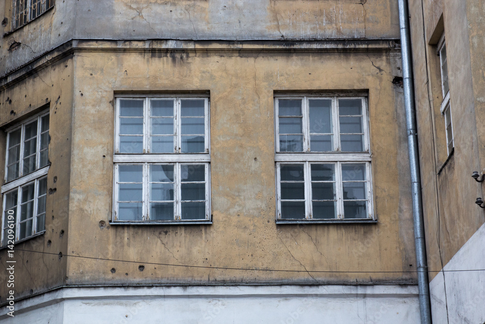 Windows on the facade of an old abandoned house