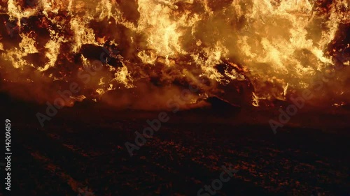 Fire storm, horrific fire destroys gigantic hay bales construction, Red Epic slow motion clip