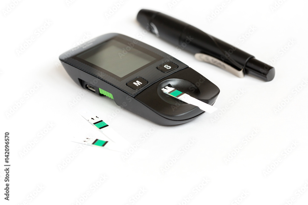Set glucometer and syringe with Diabetes Indicator Strips For Blood Glucose Testing Isolated on white background Set glucometer and syringe with Diabetes Indicator Strips For Blood Glucose Testing Isolated on white background