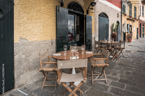 Wooden table near traditional Italian cafe in Portofino town, Italy © gorelovs