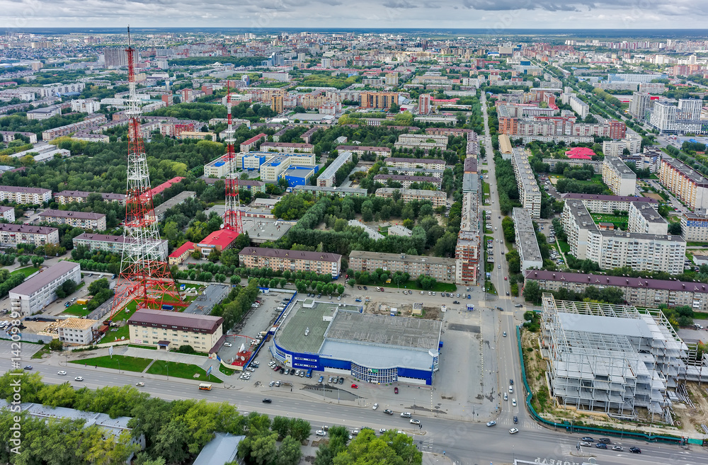 Tyumen, Russia - August 9, 2015: Bird's eye view on TV tower, shopping center, construction site and residential districts