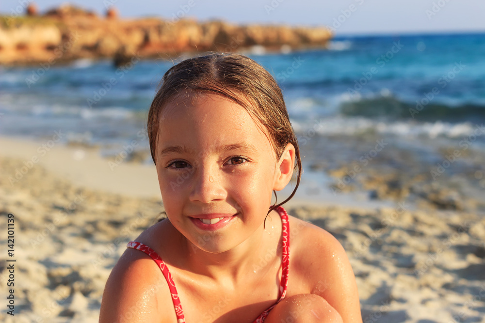 preteen photo Happy Cute preteen Girl sitting and smiling on the coast of warm Sea at Summer Sunset Stock 写真 | Adobe Stock