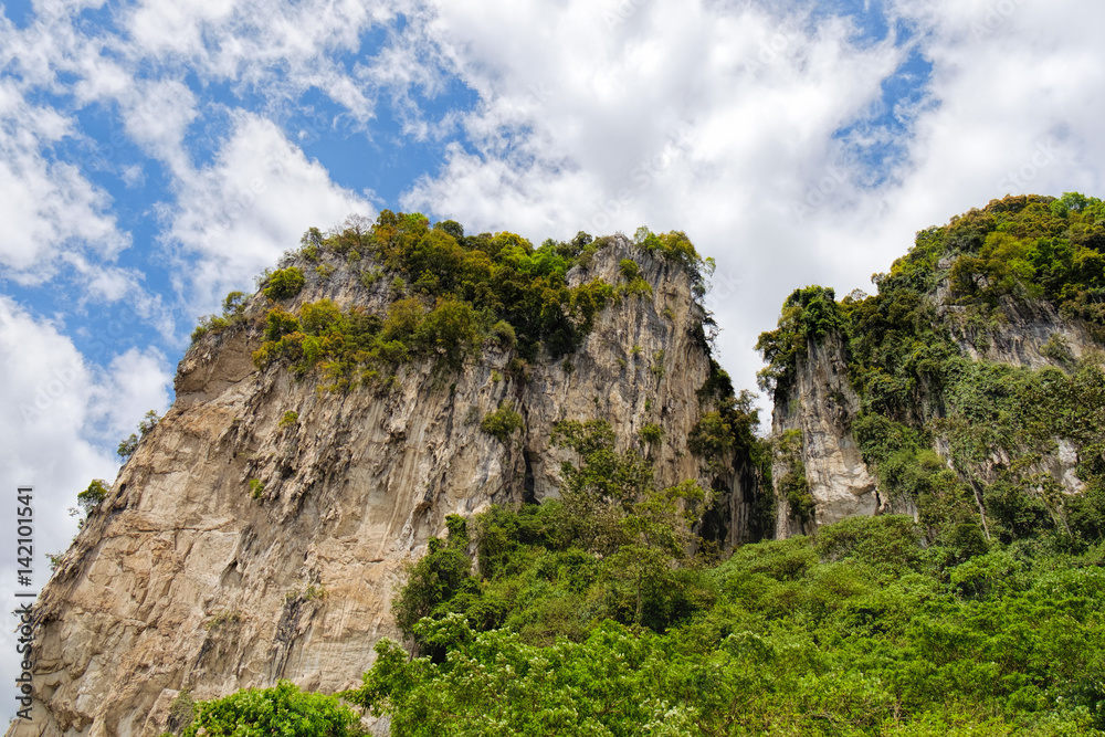 Limestone hills covered with tropical forest in Batu Caves, Malaysia.