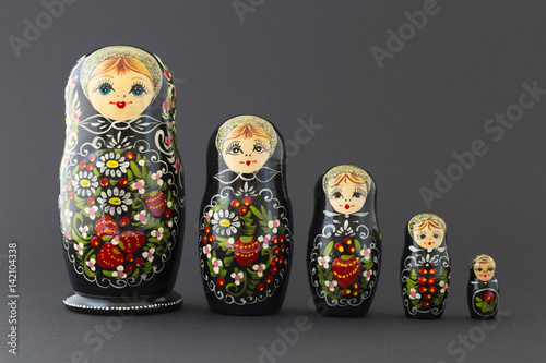Fotografering Beautiful black matryoshka dolls with white, green and red painting in front of