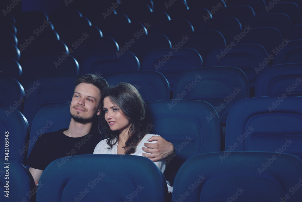 Couple embracing and sitting alone in cinema halll. Couple embracing and sitting alone in cinema halll.