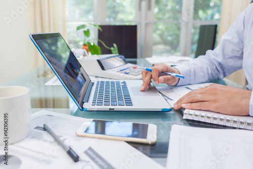 Business man working on open laptop at home office