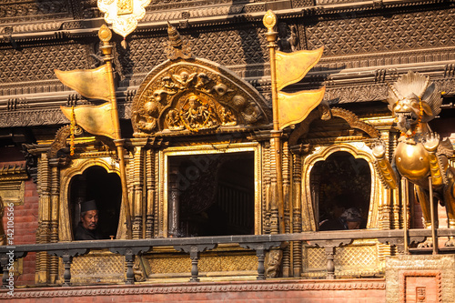 November 28, 2013 Man looks from window of one of the temples in the streets of Kathmandu durbar square photo
