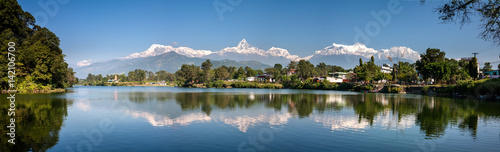 View at Annapurna mountain range and its reflection in Phewa lake in Pokhara, Nepal photo
