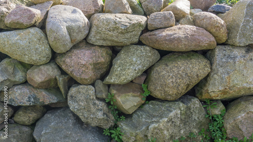 Field stone wall in the garden at sunshine