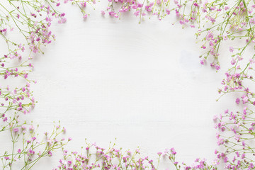 White wooden table with pink flowers, welcome spring concept