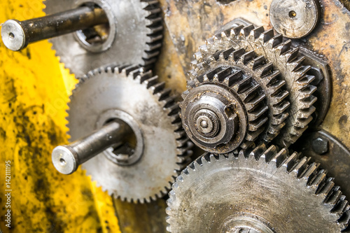 Old rusty gears of the yellow machine