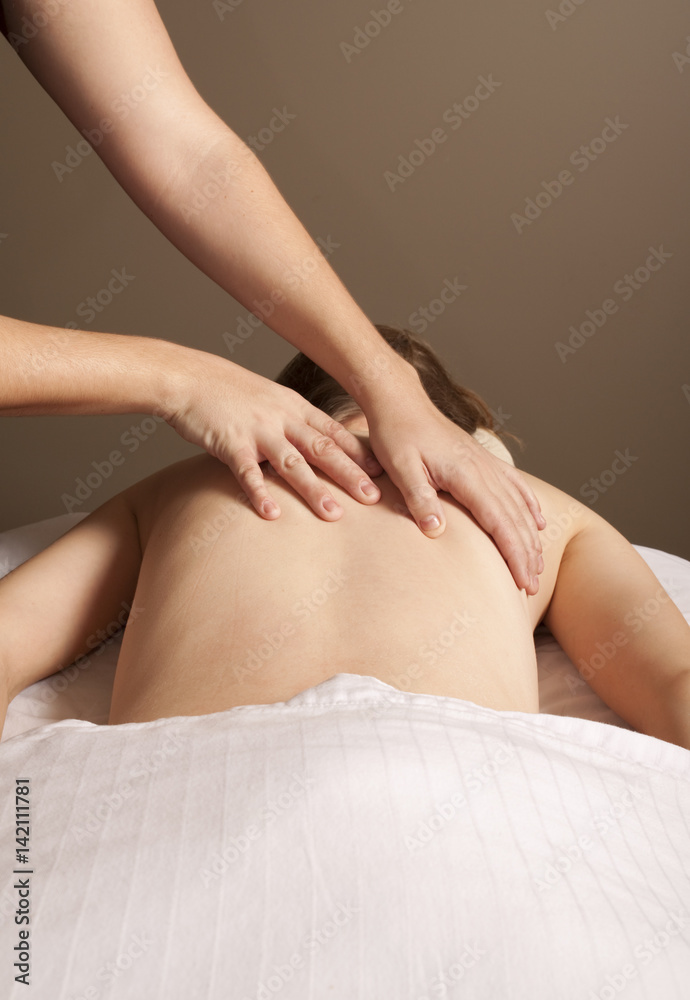 Massage therapist massaging client