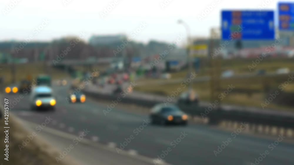 Unfocused view on fast moving cars on the road. Defocused highway traffic Unfocused view on fast moving cars on the road. Defocused highway traffic