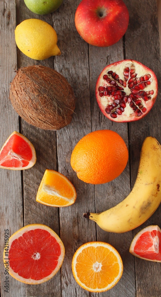 Fresh fruits. Mixed fruits background. Healthy eating, dieting. Background of healthy fresh fruits. Fruit salad - diet, healthy breakfast. pomegranate, persimmon, tangerine, banana, lemon 