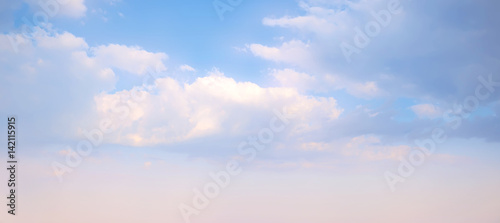 Sky background. Nature composition. Panoramic sunset sky background. Bright blue sky with lighted clouds. 