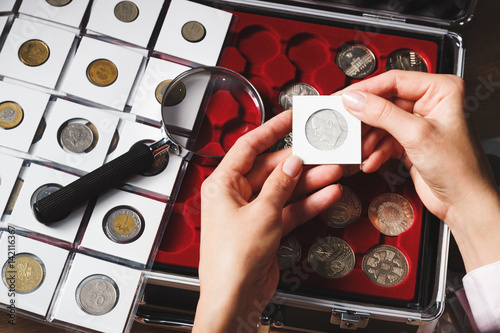Box with collectible coins and magnifying glass