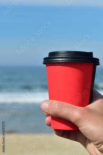 man holding a coffee